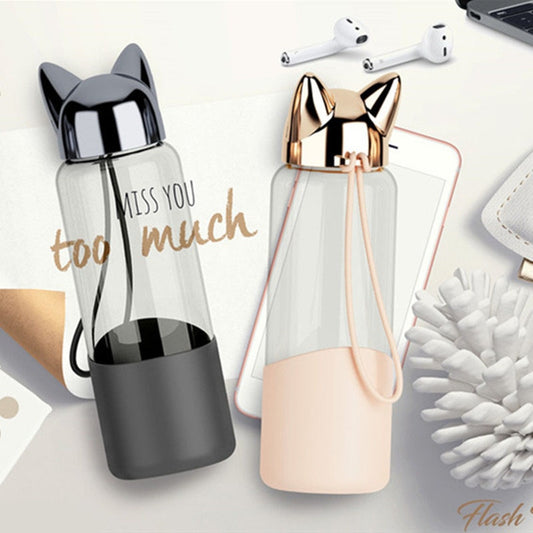 Glass water bottle with sleeve and carrying rope