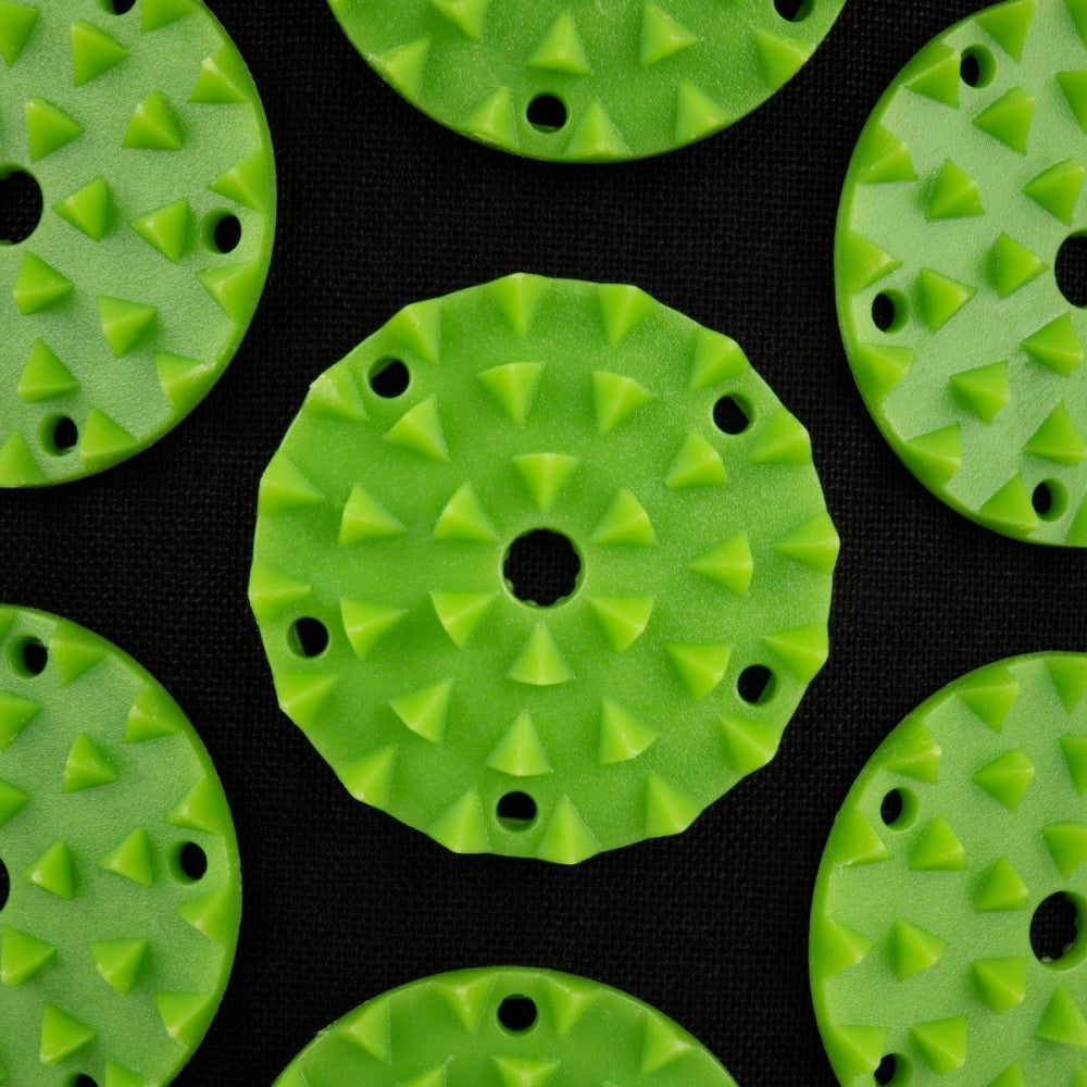 Close-up of textured green acupressure mat and pillow set emphasizing pressure points for massage and yoga benefits.