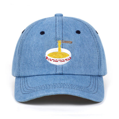 Duckbill baseball cap featuring a unique embroidered ramen bowl design with chopsticks on a blue hat.