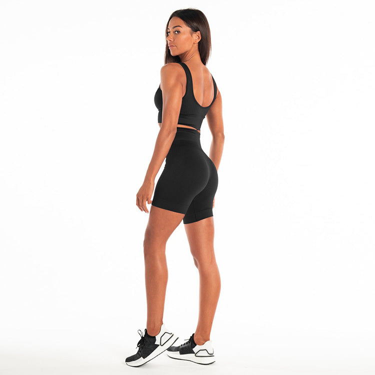 Seamless workout set for women shown from the back, featuring a black sports bra and shorts, ideal for gym and yoga.