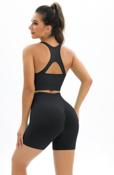 Seamless workout set for women featuring a black tank top and shorts, perfect for gym and fitness activities.